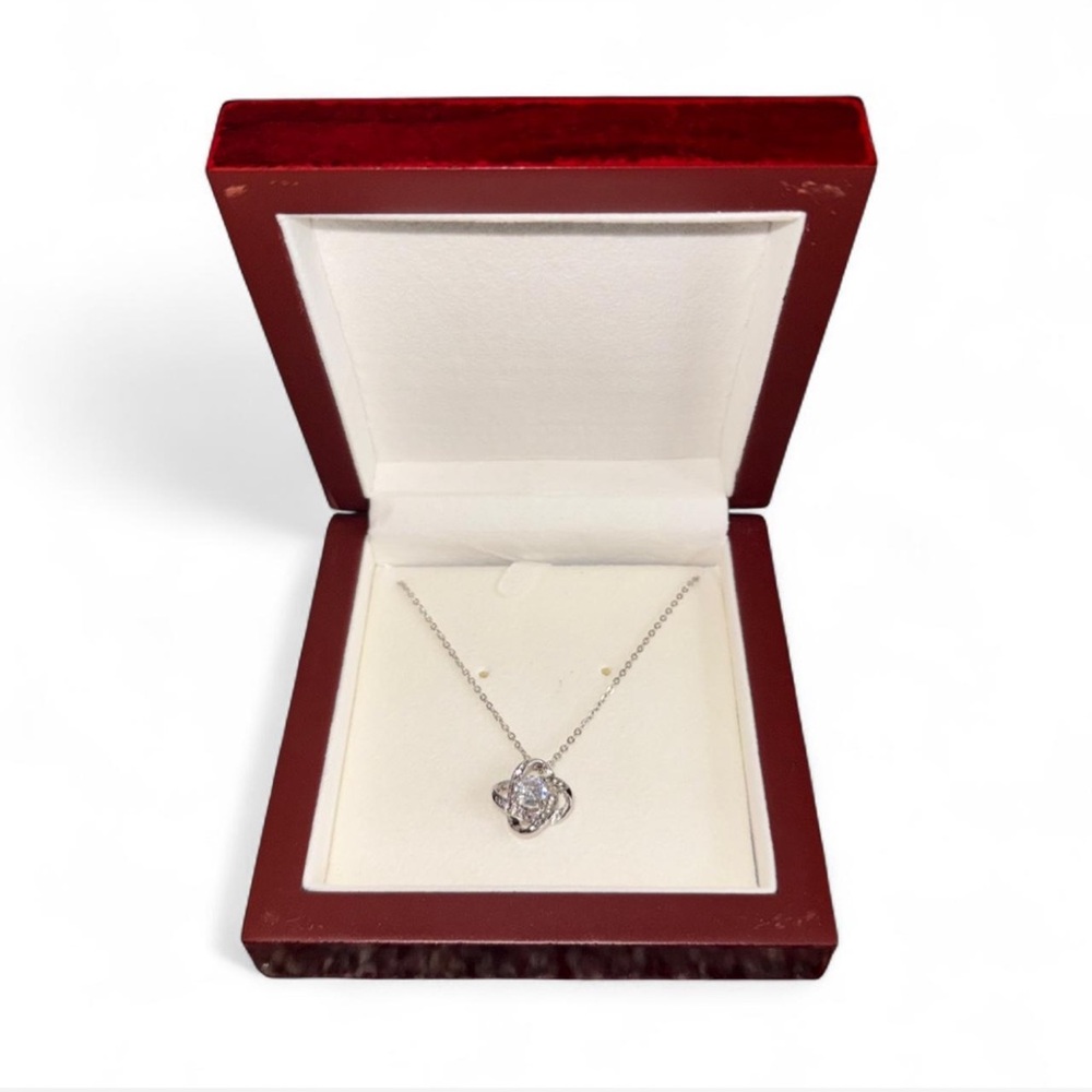 Silver diamond necklace with light showcasing gift box